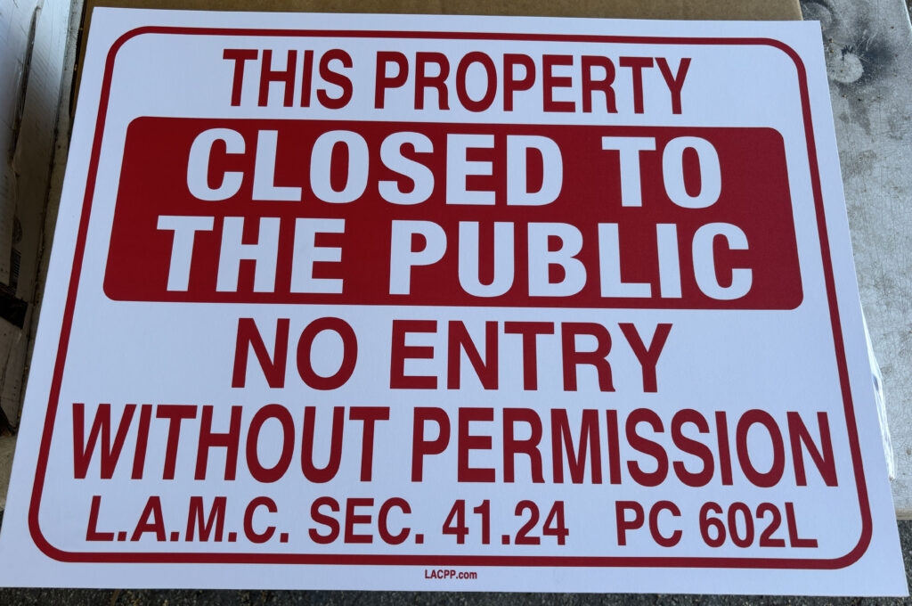 LAMC 41.24 No Trespassing sign posted on a vacant Los Angeles property warning that entry is prohibited without permission.